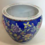 A large Chinese jardiniere, polychrome decorated with stylised flowers on a blue ground, bearing