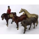 Three ceramic horses marked NL '92 together with a resin example