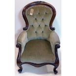 A Victorian mahogany spoon back armchair with velour upholstery