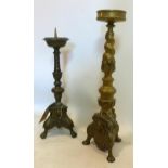 Two brass pricket candlesticks of varying size, both with knopped and twisted stems on tri-form