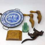 A miscellaneous collection of items to include a cast iron dog nut cracker, pair of blue and white