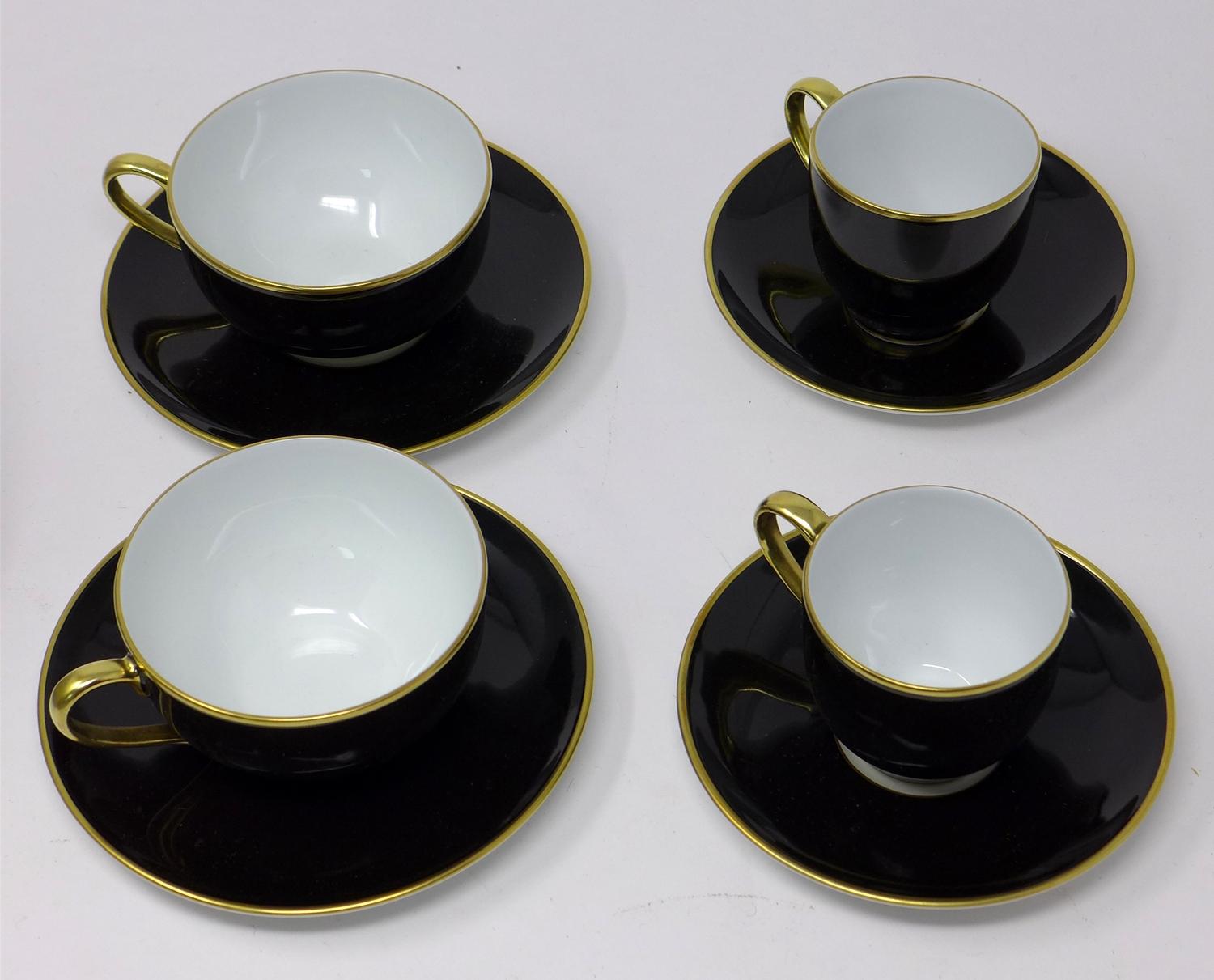 Legle Limoges, black and gold rimmed porcelain collection: 2 coffee cups and 2 saucers, 2 teacups