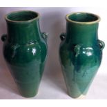 A pair of Persian green glazed Sharab wine vessels, H.75cm
