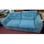A contemporary sofa with blue corduroy upholstery