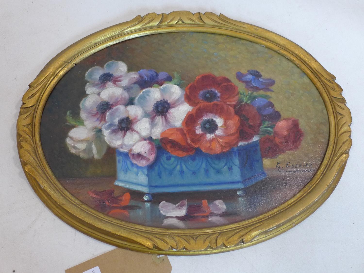 G. Corbier (French) An early 20th century oval, oil on board of a still-life of anemones in a blue