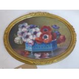 G. Corbier (French) An early 20th century oval, oil on board of a still-life of anemones in a blue
