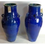 A pair of Persian blue glazed Sharab wine vessels, H.90cm (2)