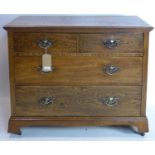 An Arts & Crafts oak chest of drawers raised on castors, H.82 W.100 D.48cm