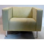 A Davison Highley suede armchair raised on chrome legs