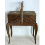 A 20th century oak sewing box raised on cabriole legs