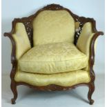 An early 20th century Rococo style carved walnut armchair