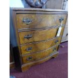 A Georgian style walnut serpentine chest of four drawers, raised on bracket feet, H.74 W.62 D.50cm