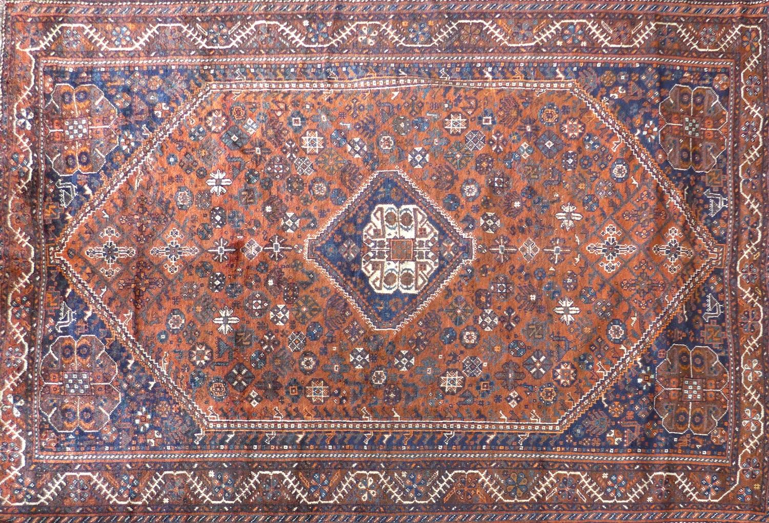 A South West Persian Qashqai carpet, central diamond medallion with repeating petal motifs on a