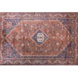 A South West Persian Qashqai carpet, central diamond medallion with repeating petal motifs on a