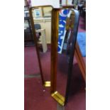 A pair of gilt and black metal mirrors, 130 x 30cm