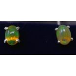 A boxed pair of sterling silver and opal cabochon stud earrings - hues of green, pink and orange g.