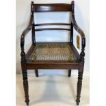A 19th century mahogany armchair with cane seat