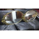 A pair of French gilt metal oval mirrors, 82 x 48cm