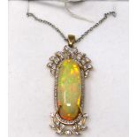 A 14ct yellow and white gold, large natural, oval opal and diamond set pendant on an 18ct yellow