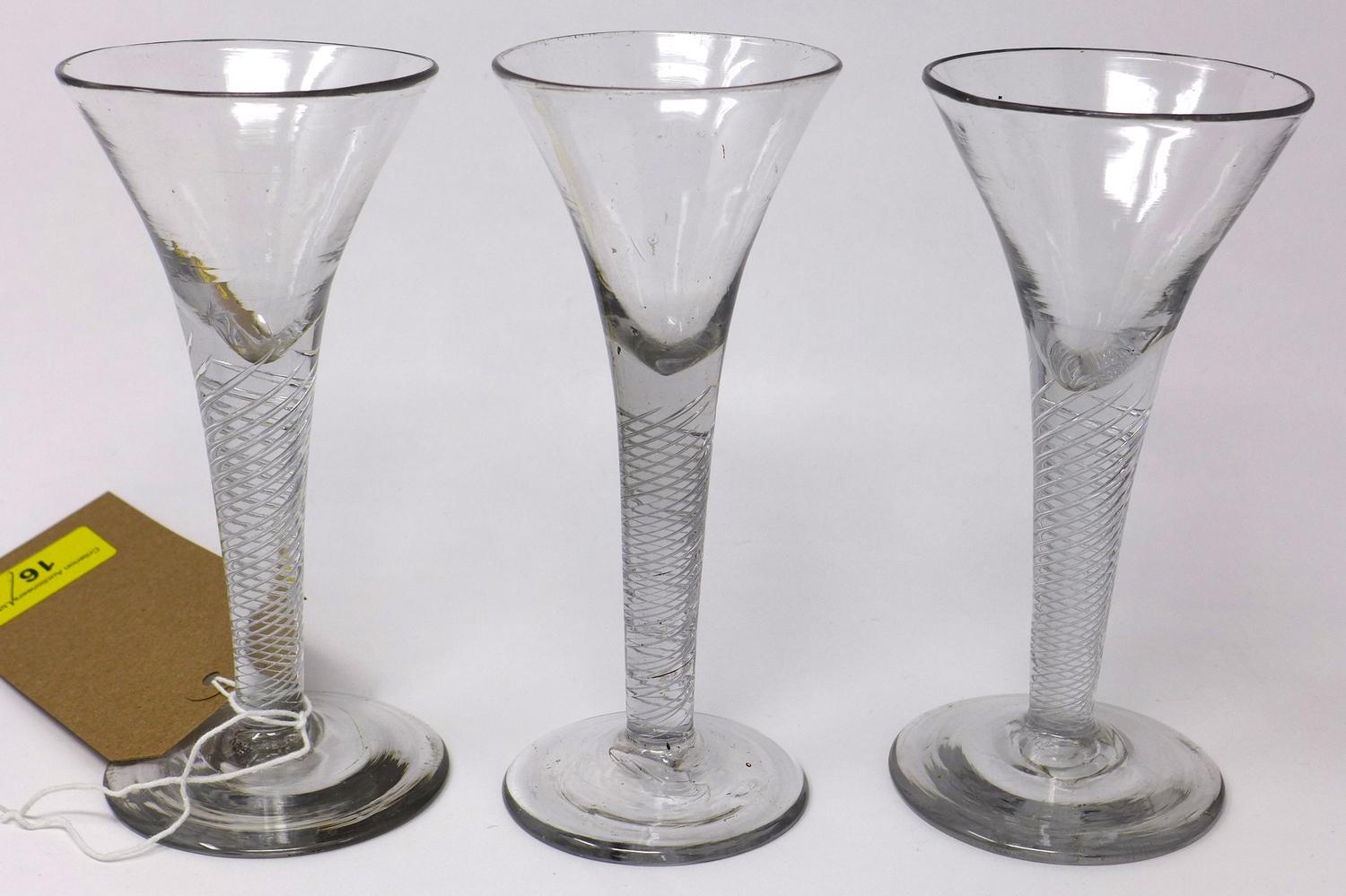 Three Georgian wine glasses with twist stems, on circular bases, H.17cm