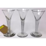 Three Georgian wine glasses with twist stems, on circular bases, H.17cm