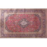 A Central Persian Kashan carpet, central double pendent medallion with repeating spandrels on a