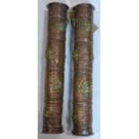 A pair of Tibetan repousse copper scroll holders both adorned with brass roundels depicting