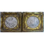 A pair of reconstituted marble plaques with bronze foundry buttons to verso, set in gilt frames,