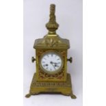 A late 19th/early 20th century French brass mantle clock, with lion finial and paw feet, H.41 W.23