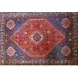 A zoomorphic Qashqai carpet on a red & blue ground, contained by geometric borders, 320 x 226cm