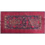 A North East Persian Meshad Belouch rug, double pole medallion on a midnight field, within