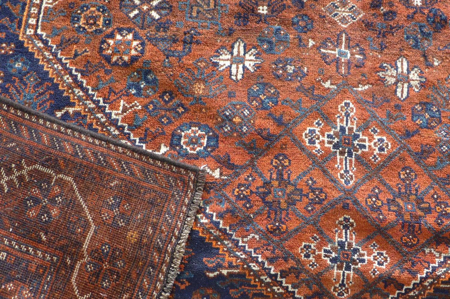 A South West Persian Qashqai carpet, central diamond medallion with repeating petal motifs on a - Image 2 of 2