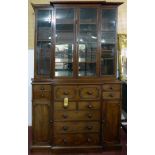 A Regency mahogany breakfront secretaire bookcase, with four glazed doors enclosing adjustable