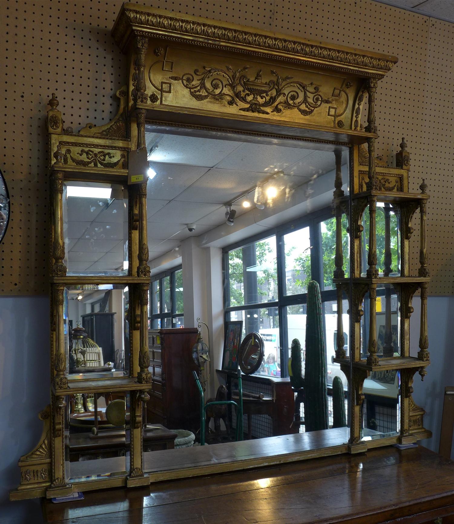 A large early 19th century giltwood mirror, having bevelled glass plates, the central plate