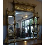 A large early 19th century giltwood mirror, having bevelled glass plates, the central plate