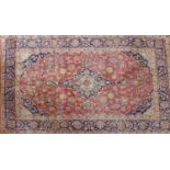 A Central Persian Kashan rug, central double pendent medallion with repeating petal motifs on a