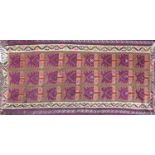 A 20th century Kelim carpet with repeating geometric purple motifs, contained by geometric border,
