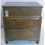 An 18th century oak box on chest, hinged compartment over two drawers, raised on bun feet, H.85 W.76