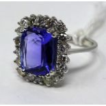 An 18ct white gold brilliant cut diamond and tanzanite ring, Size: g.