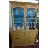 A 20th century pine dresser, with two glazed cupboard doors revealing turquoise painted interior,