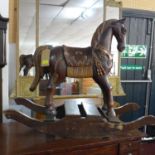 A carved wooden rocking horse, H.69 W.100 D.36cm