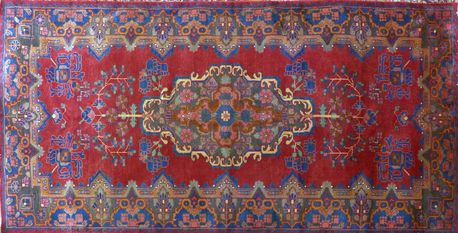 A Central Persian Bakhtiari carpet, central double pendent medallion with repeating petal motifs