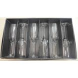 A boxed set of 6 Mario Cioni, Italian, hand-blown clear glass champagne flutes, all engraved to