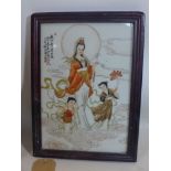 A 20th century Chinese porcelain plaque hand-painted with a female deity and two young children