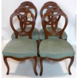 A set of four early 20th century mahogany dining chairs with velour upholstery