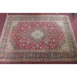 A Central Persian Kashan carpet, central double pendent medallion with repeating petal motifs and