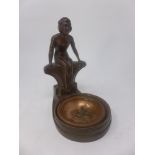 An Art Deco style metal dish, with seated lady finial, and copper dish, H.19cm