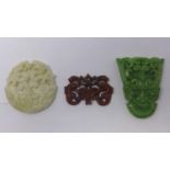 Three 20th century Chinese hand-carved hardstone amulets/pendants in shades of green, white and