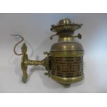 A brass wall mounted oil lamp, converted to electricity, H.28 D.25cm
