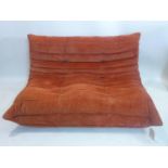 A Ligne Roset Togo sofa, with terracotta coloured upholstery, H.70 W.135 D.100cm